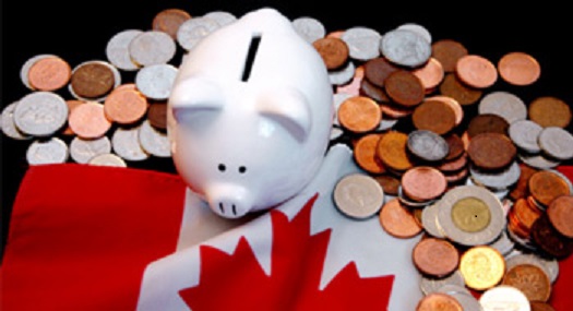 White piggybank on Canadian flag with coins around it