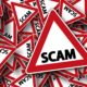 red and white warning signs with the word Scam